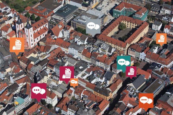 Foto der Stadt Fulda mit Blick von oben. Integriert sind die Icons vom Mängelmelder Fulda. Der digitale Bürgerservice ist zum 1.11.23 zunächst im Testbetrieb gestartet.